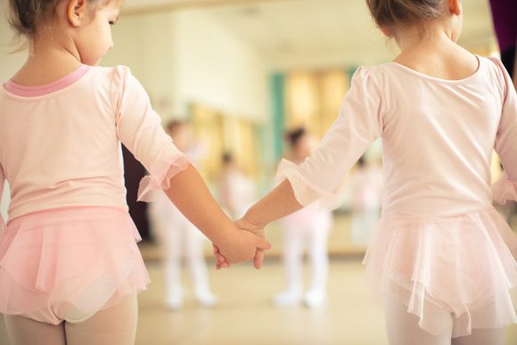 Beginning ballet dancers hold hands